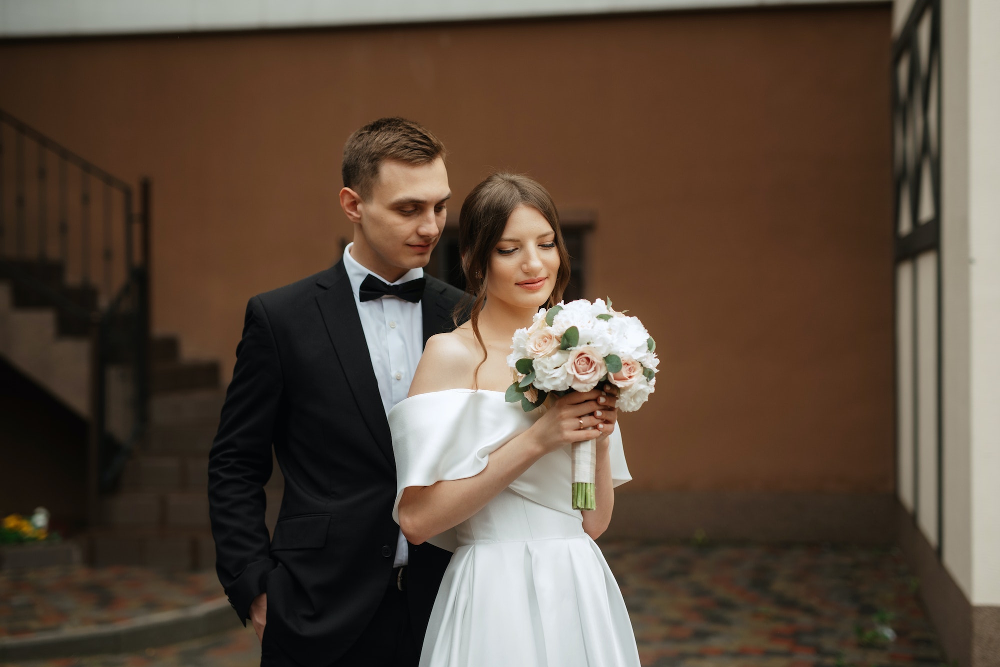 young couple bride and groom in a white short dress