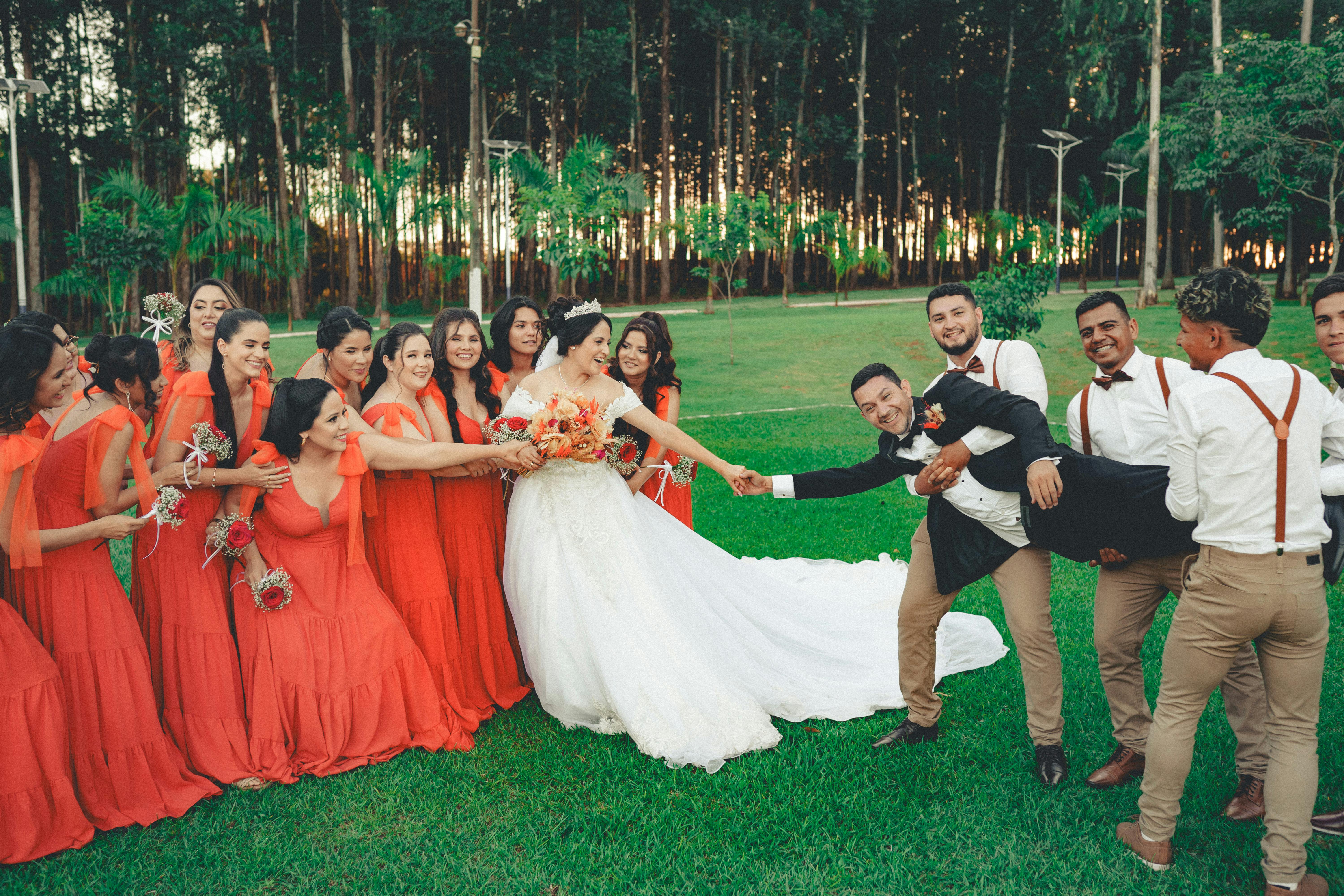 Stylish happy bride and groom toasting with glasses of champagne and having fun